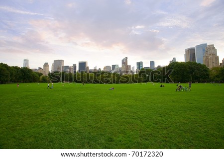 panorama view of New York City Central Park with Manhattan skyline and skyscrapers.