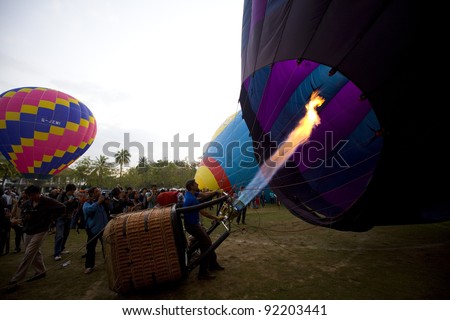 CHIANG MAI - NOV 26: Unidentified man fills hot air in balloon during Thailand balloon festival 2011 at Prince Royal college in Chiang mai, Thailand on Nov 26, 2011.