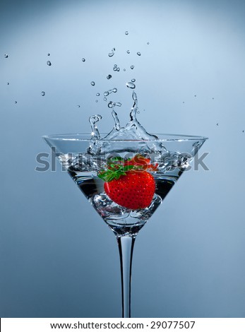splashing strawberry into a martini glass