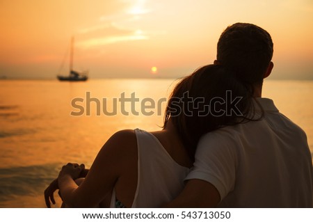 https://image.shutterstock.com/display_pic_with_logo/3625397/543713050/stock-photo-romantic-portrait-of-attractive-couple-in-love-hugs-sitting-on-the-beach-at-the-sunset-on-tropic-543713050.jpg