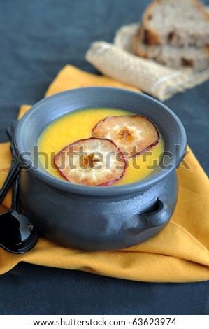 Cream of pumpkin and apple soup garnish with apple chips