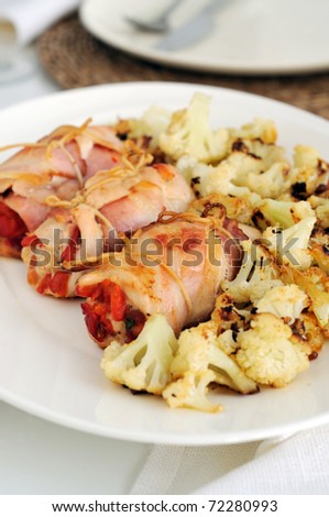Stuffed bacon and chicken rolls with roasted pepper. Roasted cauliflower