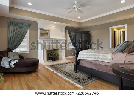 Master bedroom with fireplace and rug