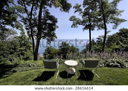 Lawn chairs and view of lake in luxury home