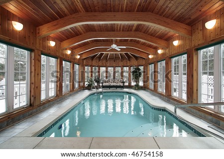 Swimming pool in luxury home with wood ceiling beams