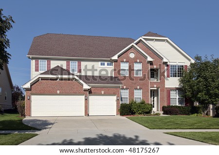 Brick home in suburbs with three car garage