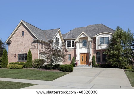 Large suburban brick home with arched entry