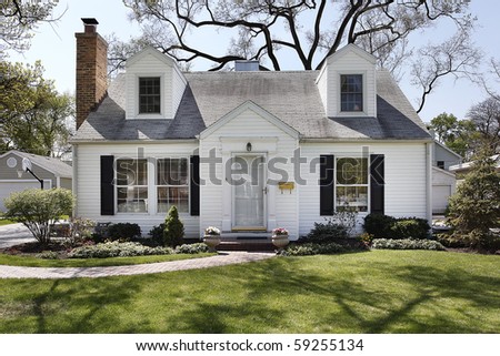 White home in suburbs with brick sidewalk