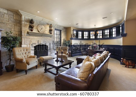 Basement in luxury home with stone fireplace