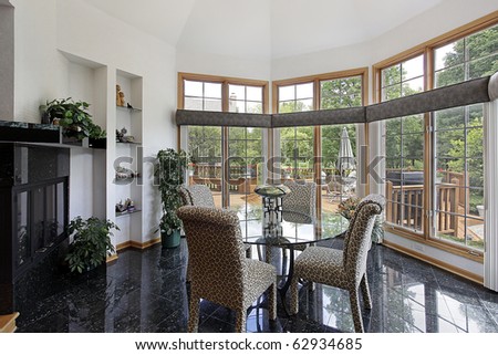 Breakfast room in luxury home with walls of windows