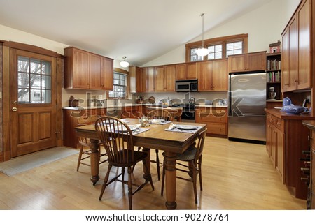 Large kitchen in luxury home with oak wood cabinetry
