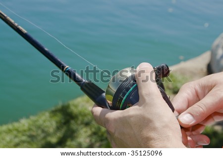 Hands holding a fishing pole