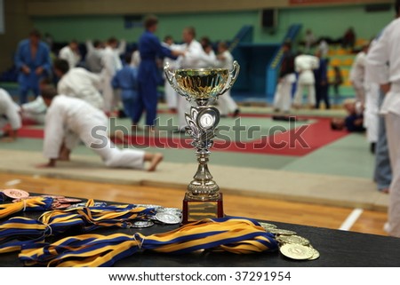 cup and medals on a background sportsmen