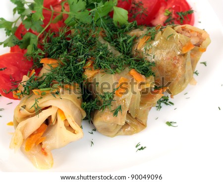 Stuffed cabbage rolls with tomato and parsley.