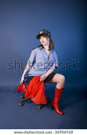 nice girl is sergeant of militia in photographic studio