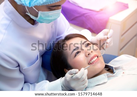 Similar – Image, Stock Photo Dentist treating teeth of patient with UV light