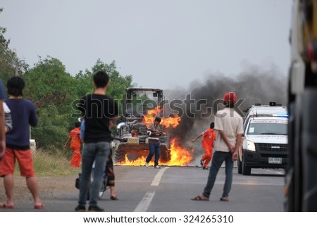 NAKHON RATCHASIMA, THAILAND â?? JANUARY 11, 2015: Fire and black smoke on the road after a tractor collision in Nakhon Ratchasima on 11 January 2015