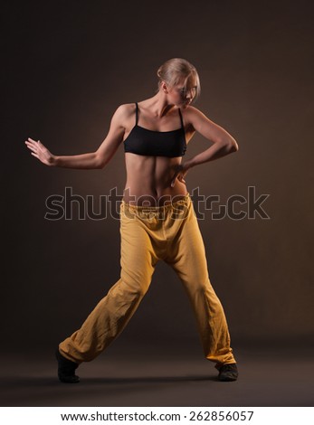 Dynamic dance in photostudio. young beautiful blonde woman in motion