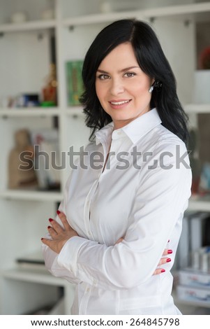 She work in start up office. Portrait of white collar worker in office