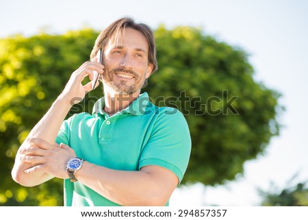 Confident businessman talking on mobile phone. Handsome caucasian businessman using mobile phone focused in the work.