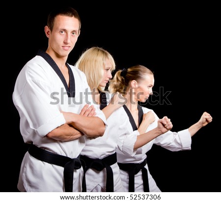 Group of young people in kimono that make  martial arts exercise