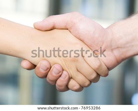 Handshake between office workers - man and woman