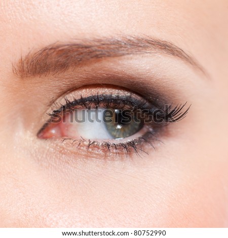 Close up of creative make up on female green eye (focus on eyelashes)