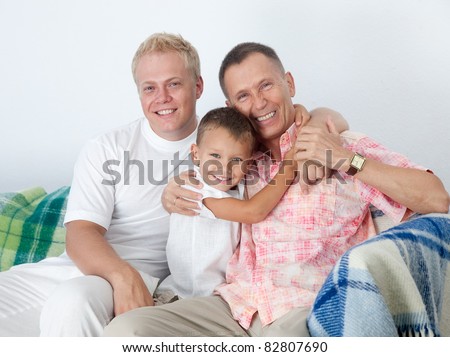 Grandfather, father and son posing for camera