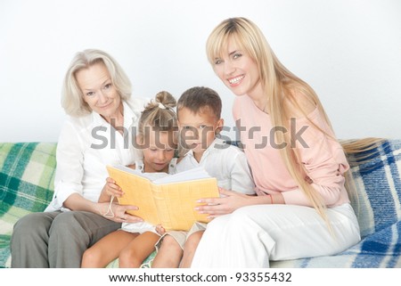 Mother and grand mother read book with children