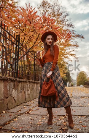 Similar – Image, Stock Photo Woman in brown boots standing on a wooden floor holding a dried artichoke flower in her hand