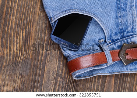Phone in pocket blue jeans with black screen
