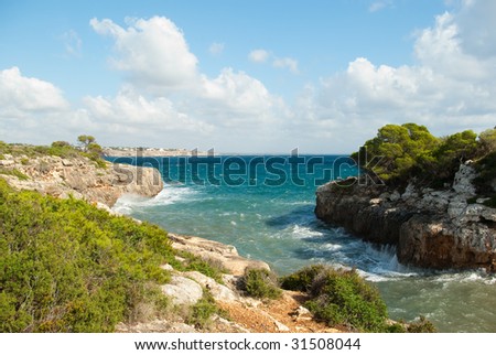 Bay of the Mediterranean sea between the rocks with green trees