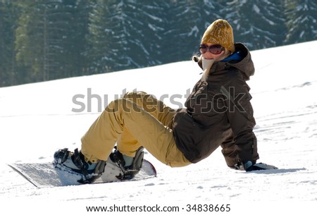 Girl with snowboard on a snowy hill