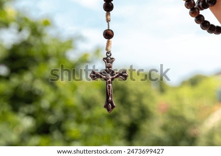 Similar – Image, Stock Photo A rosary hangs from an open Christian prayer book with the Our Father