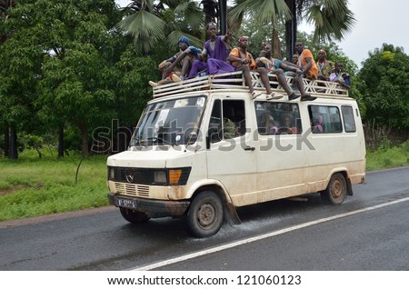 KARTIAK,SENEGAL-SEPT 18:people in the bus roof go to ritual of Boukoutt of Initiation ceremony on Sept 18,2012 in Kartiak,Senegal.The ceremony occurs every 30 years and celebrates boys becoming men