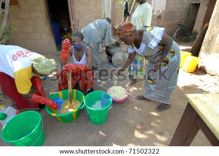 OUAGADOUGOU,BURKINA FASO -  MARCH 4: African women produce shea butter on March 4, 2005 in Ouagadougou, Burkina Faso. Shea Butter is used in Africa for food and is widely used in cosmetics as a moisturizer.