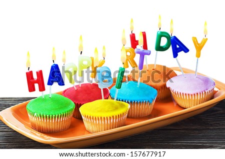 colorful happy birthday cupcakes with candles on white background