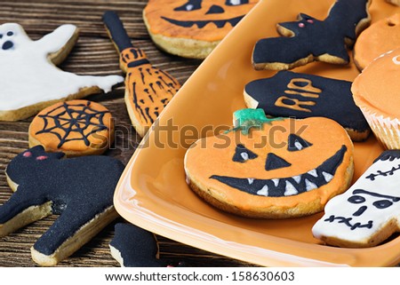 Halloween cookies on orange plate and wooden table
