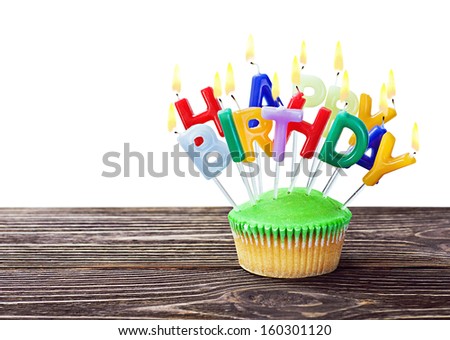 colorful happy birthday cupcake with candles on white background