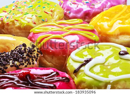 Glazed donuts in the range of background. Focus on middle frame