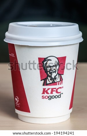 Moscow, Russia - May 22, 2014: Paper cups with coffee KFC logo on the table. KFC U.S. chain of cafes, specializing in chicken dishes. Was founded in 1952, Harland Sanders