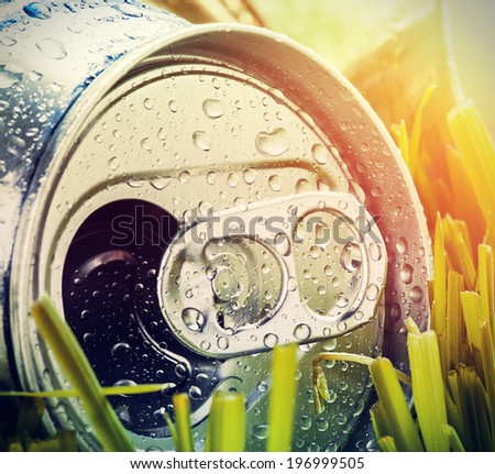 aluminum cans on a green Grass. Focus on aluminum cans