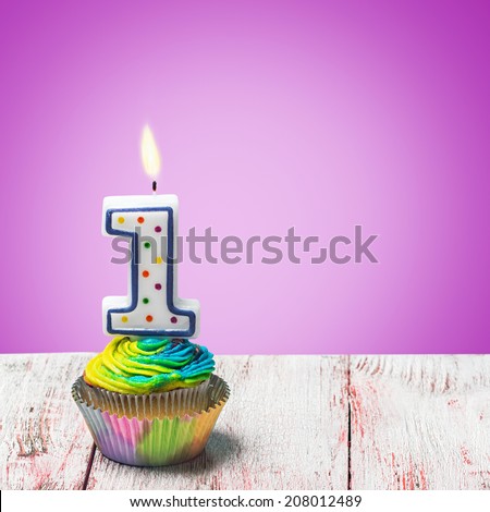 Cupcake with number one on a purple background. birthday greetings