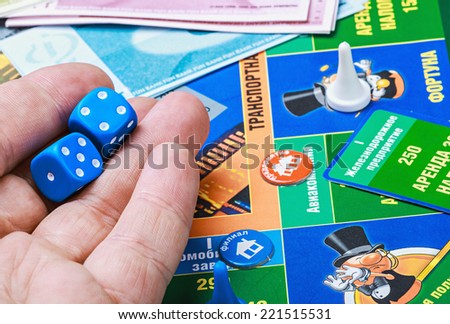 Moscow, Russia - September 11, 2014: Monopoly game on the table. Monopoly game in Russian, a board game in the genre of economic strategy for two or more people.
