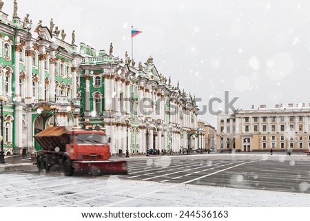 snow removal on the Palace Square in St. Petersburg. Russia, winter, dawn. Focus on the central entrance of the palace, on the left