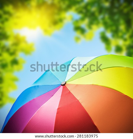 Rainbow umbrellas against the backdrop of nature. focus on umbrella
