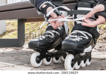 dressing roller skates for skating. focus in the middle of the frame on roller skates