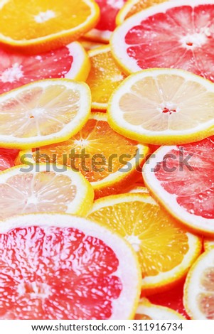 background with citrus-fruit of Fresh fruit slices. focus in the middle of the frame, shallow depth of field