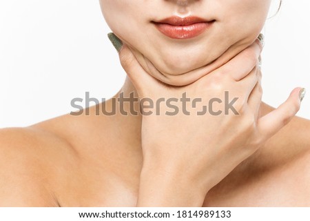 A woman who pinches the fat on her jaw. Imagine de stoc © 