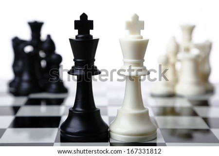 Black and white chess pieces merging together on white background